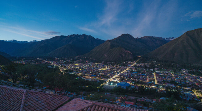 Scenic panoramic landscape of Urubamba, a town in the Sacred Valley of the Incas in southern Peru, featuring lush agricultural fields and spectacular mountains of the Andes.