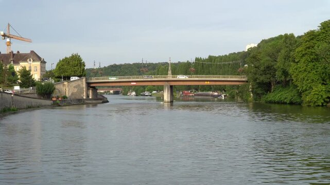 Picturesque panoramic view showcases the Oise river flowing through the city of Creil in northern France.