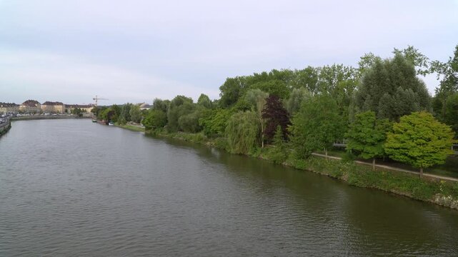 The Oise river surrounded by a natural landscape in the outskirts of Creil, city in northern France.
