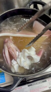 Boiling Fresh Squid In Hot Boiling Water Pot 4K Cinematic Video