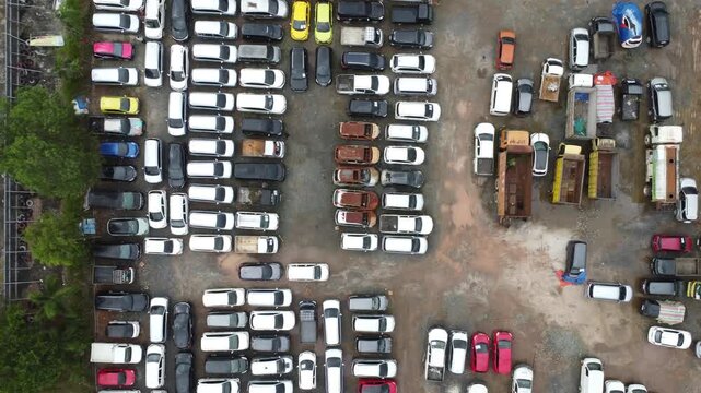 Aerial view of cars parked in a row for auction, there are various types of cars