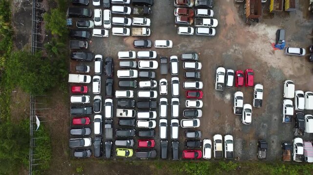 Aerial view of cars parked in a row for auction, there are various types of cars