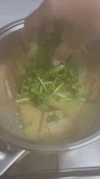 Adding Fresh Vegetable Garnishes On Hot Korean Fish Cake Soup 4K Cinematic Video