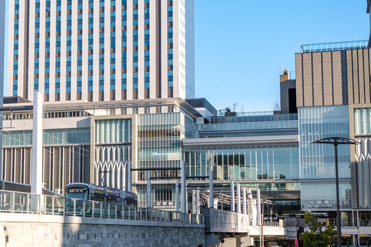 JR Hiroshima Station with street car running in the foreground during day time, which is an integrated facilities with shopping malls and street car terminus in Hiroshima, Japan on 22 Dec 2025