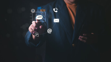 Businessman touching a digital AI chatbot assistant icon for automated customer service. Concept of smart artificial intelligence communication online help desk, and futuristic virtual support.