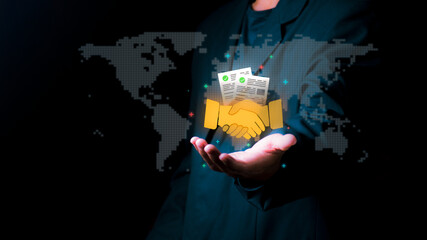 Global business partnership concept with a person holding a glowing handshake icon and world map. Ideal for international cooperation, successful merger and digital contract agreement.