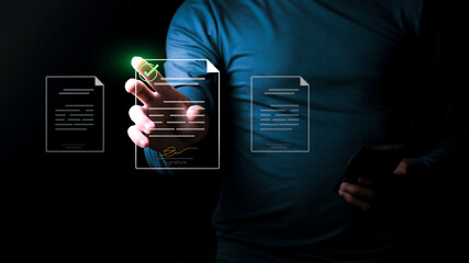 Businessman signing a digital document with an electronic signature on a virtual screen, Concept of paperless office secure legal contract management, and online transaction agreement technology.