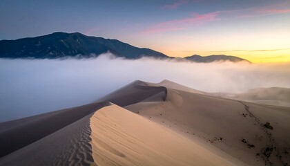 Dune ridges and misty mountain at dawn, bathed in warm sunlight, serene and spacious