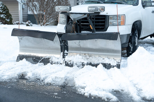 truck with snowplow installed on the driveway