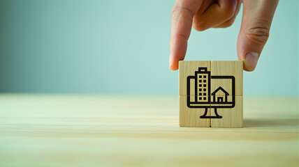 Illustration of a hand holding a wooden block with icons of buildings and a computer on it, representing remote work and real estate concepts