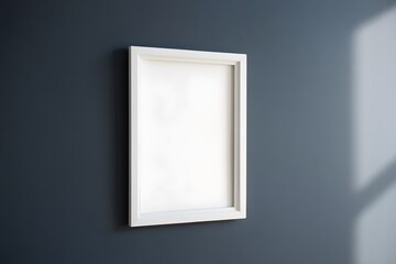 White picture frame on gray wall with sunlight