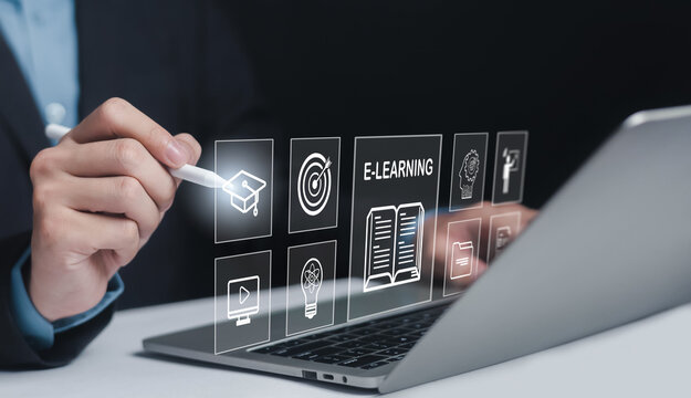 Business professional using e-learning interface on laptop with graduation cap, digital book, target, and knowledge icons, representing online education technology, smart learning platform.