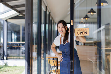 Fototapeta premium Startup successful small business owner sme beauty girl stand with arms crossed in coffee shop restaurant. Portrait of asian tan woman barista cafe owner SME entrepreneur seller business concept
