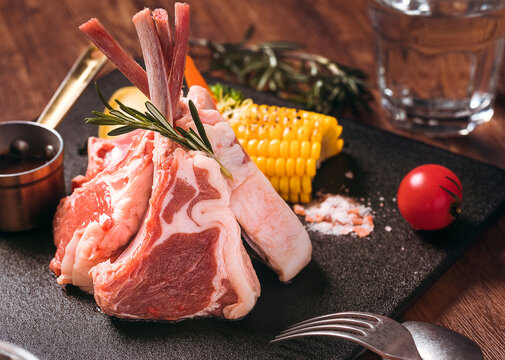 Fresh Raw Lamb Chops on Wooden Kitchen Table