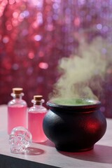 a red, glowing cauldron with green smoke coming out and around it. skull shaped crystal bottles sit on the table next to the black pot filled with a pink liquid. the background is a glittery
