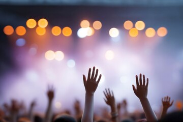 blurred concert crowd in front of stage lights with hands raised, night lighting, and an orange color tone. the concept for a live music event background.