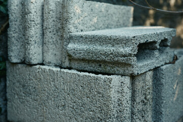 Concrete blocks stacked in a rough outdoor pile, highlighting cement texture and industrial building materials for construction, masonry, and foundation projects
