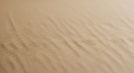 Abstract close-up of light brown suede or leather texture with subtle diagonal wrinkles and shallow depth of field.