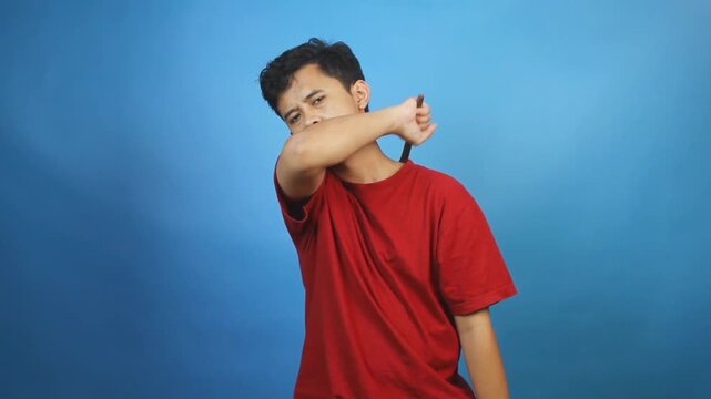 Asian man scratches itchy body part with scratcher