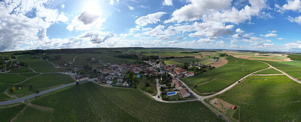 Trois-Puits, Reims, Marne, Grand-Est, France, August, 28th, 2025, Champagne Area, This breathtaking aerial shot captures a quaint village beautifully nestled among vibrant green fields and landscapes