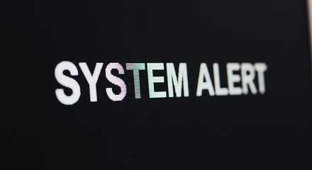 System Alert message displayed on a dark computer screen, indicating a critical technical error, security warning, or operational failure