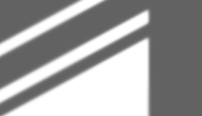 Abstract overlay effect of two strong diagonal stripes of light and shadow on a wall illumination surface and dark pattern backdrop