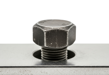 Close up of black hexagonal bolt head screwed into metal plate on a transparent background