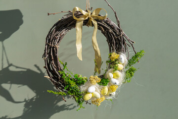 Handmade Easter wreath festive yellow egg decorations. Traditional holiday preparation craft creative decor. Sustainable responsible holiday gift workshop creation. Copy space Simple ideas green