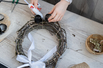 Handmade Easter wreath festive yellow egg decorations. Traditional holiday preparation craft master class of creative making decor. Hands-on activities sustainable responsible holiday gift workshop