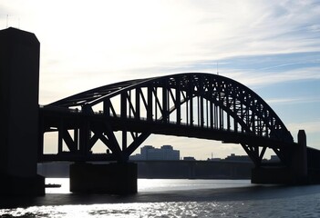 Fototapeta premium Sleek, dark bridge silhouette against bright sky, artwork, element