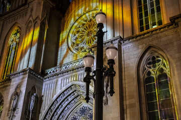 Sao Paulo, Brazil. Dec 21, 2025. Christmas light projections on the facade of the Se Cathedral. Neo-gothic architecture illuminated with colorful stained glass patterns for the holiday season