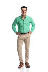 Fototapeta premium Happy young casual man standing with hands on hips