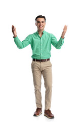 Fototapeta premium Enthusiastic young man standing with open arms