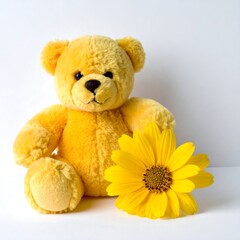 Obraz premium A yellow teddy bear sitting next to a large yellow flower