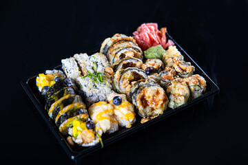 Assorted Japanese sushi rolls arranged as a sushi set on a plate, universal food photography suitable for restaurant menus, delivery services and advertising.
