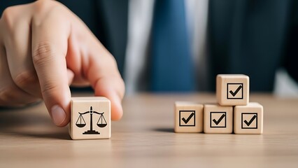 Naklejka premium Hand places wooden cube with scales of justice symbol next to checkmark cubes wooden cubes checklist