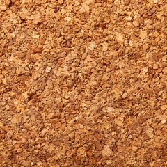 Fototapeta premium A dense field of small, irregular, natural cork granules forms a rich, organic, textured surface for backgrounds.