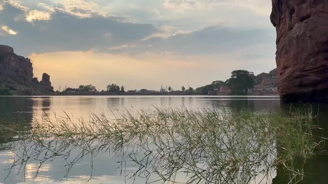 A slow-motion view of calm Agastya Lake, with gentle clouds drifting across the sky