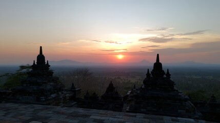 Sunset Over Ancient Temple Ruins with Silhouetted Stupas and Mountain Horizon