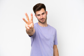 Fototapeta premium Young caucasian man isolated on white background happy and counting three with fingers