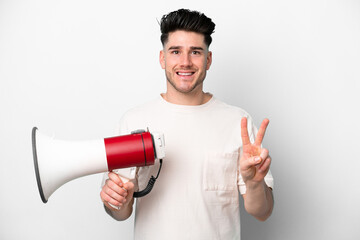Young caucasian man isolated on white background holding a megaphone and smiling and showing...