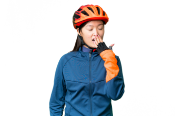 Young cyclist woman over isolated chroma key background yawning and covering wide open mouth with hand