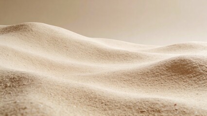 Sand dunes with soft texture in neutral tones and warm lighting  