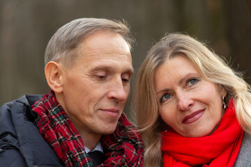 Couple enjoying a quiet moment together in a park during a chilly afternoon in autumn
