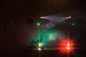Lighting setup creates an energetic atmosphere for a live music event in a venue during the night