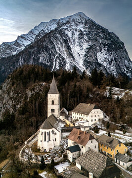 P&uuml;rgg village with church and Grimming mountain in winter, Styria, Austria
