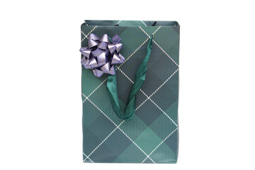 Elegant green gift bag with plaid pattern, decorative ribbon bow, and fabric handles isolated on white background. Perfect for holidays, celebrations, shopping, packaging, and luxury gift presentation