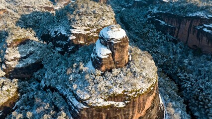 Aerial view of snow-covered rock formations in a rugged canyon landscape