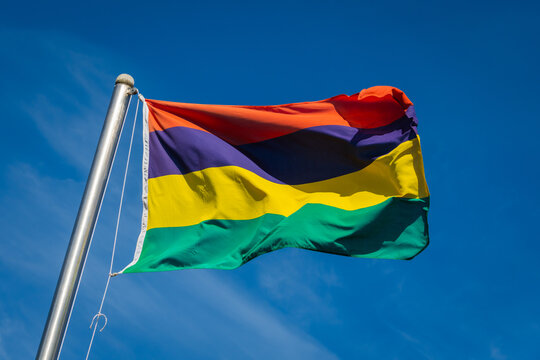 flag of Mauritius on pole  waving in the wind against blue sky