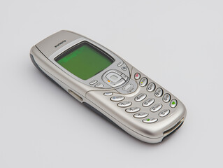 Silver mobile phone lies flat on a clean white background, showcasing its simple yet elegant design Generative AI